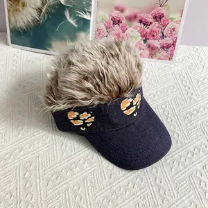 Detail of blue denim baseball cap with fluffy blonde wig hair and leopard heart patches