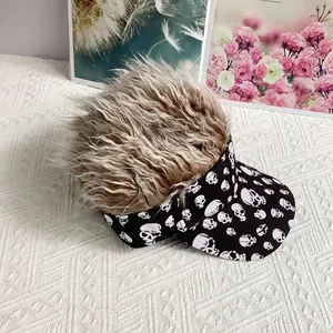 Detail of wig visor hat featuring fluffy brown synthetic hair and white skull pattern