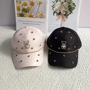 Fashionable baseball caps with rhinestone bear and floral patterns in pink and black