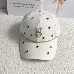 Detail of white baseball cap with rhinestone bear, heart pearl and jacquard texture