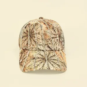 Detail of the feather print baseball cap with silver star rivets and metal studs