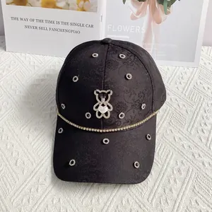 Detail of floral jacquard baseball cap featuring rhinestone bear and heart pearl