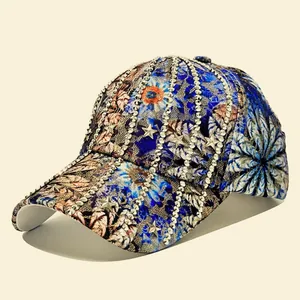 Detailed view of striped baseball cap with floral print, silver rhinestones and star rivets