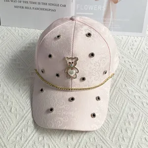 Detailed embroidery of floral pattern and rhinestone bear on a pink baseball cap