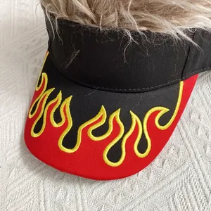 Détail du motif de flamme brodé et de la perruque brune sur la casquette visière