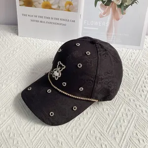 Detailed view of jacquard baseball cap with pearl bear emblem and sparkling rhinestone trim