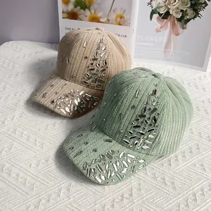 Detail of rhinestone clusters on beige and green corduroy velvet baseball caps
