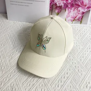 Detail of rhinestone butterfly pattern on off-white cotton baseball cap for women
