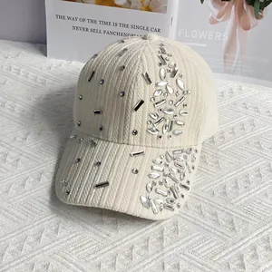 Detail of cream velvet baseball cap showing corduroy texture and silver rhinestone crystals