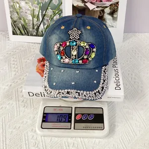 Macro shot of a denim baseball cap featuring a gemstone crown and rhinestone brim detail