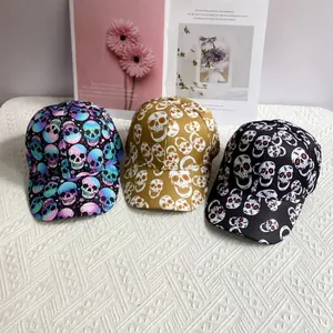 Three hip-hop baseball caps with skull prints in purple, yellow, and black colors