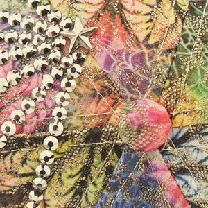 Detailed macro view of tropical floral print fabric with glitter and silver rhinestones