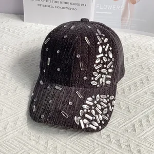 Detailed close-up of velvet baseball cap with sparkling rhinestone embellishments