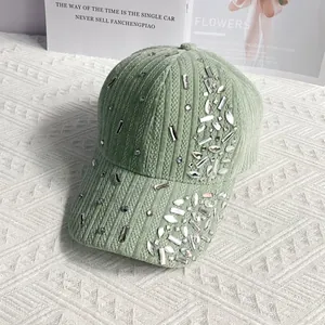 Detail view of light green corduroy baseball cap with sparkling rhinestone embellishments