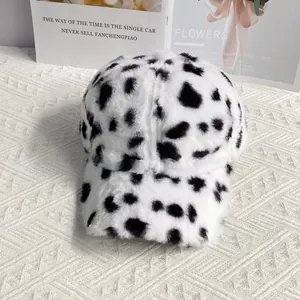Close-up of soft cow print faux fur baseball cap with thick plush texture for winter