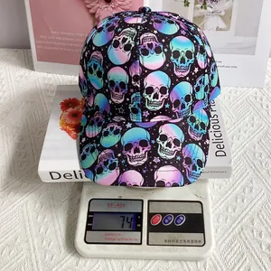Detail shot of a black skull print baseball cap being weighed on a scale showing 74g