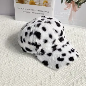 Close-up of the soft plush cow print texture and curved brim of this winter baseball cap