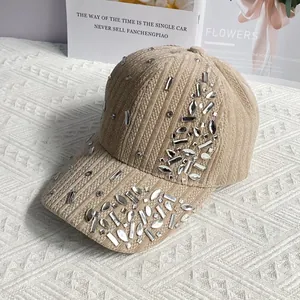 Detail of velvet baseball cap with sparkling rhinestones on beige corduroy fabric
