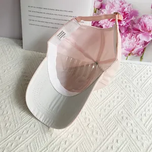 Detail view of pink baseball cap interior with adjustable metal buckle and quality lining