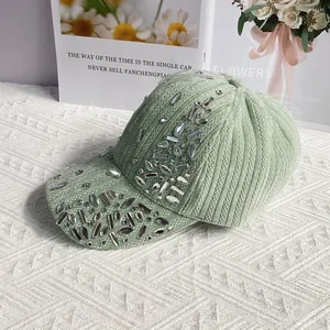 Detail of light green velvet baseball cap with sparkling silver rhinestones on brim