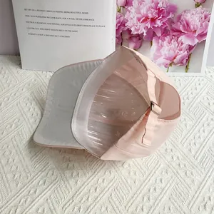 Detailed interior view of a pink baseball cap with neat stitching and adjustable metal buckle