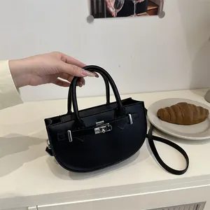 Elegant black leather semi-circular handbag with silver twist lock and crossbody strap