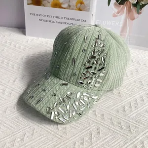 Detail of light green corduroy baseball cap with sparkling rhinestone embellishments