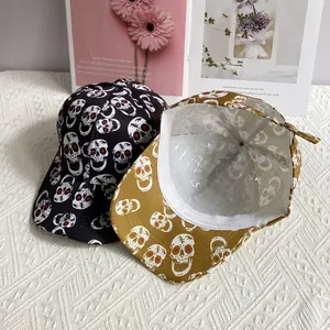 Hip hop baseball caps featuring all-over skull prints in black and mustard yellow colors