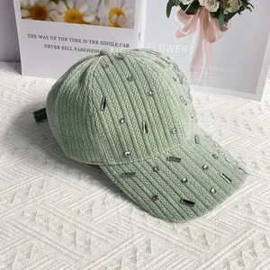 Detailed texture of light green corduroy baseball cap with sparkling crystal rhinestones