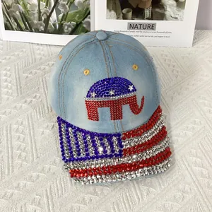 Detail of light blue denim baseball cap featuring US flag and elephant rhinestone patterns