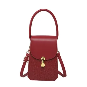 Red mini square shoulder bag with woven texture and gold hardware on white background