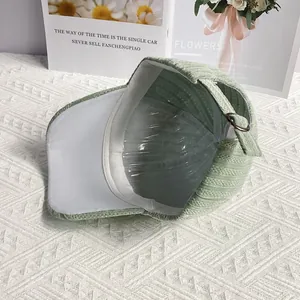 Detail of light green velvet baseball cap showing adjustable metal buckle and inner sweatband