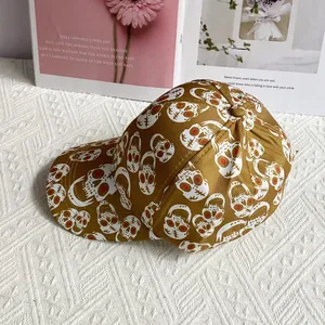 Detail of street style baseball cap with skull print on a textured fabric surface