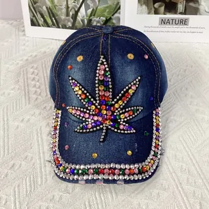 Detailed shot of dark blue denim baseball cap featuring colorful rhinestone leaf pattern