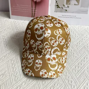 Top view of a brown hip-hop baseball cap with skull prints and red eye details