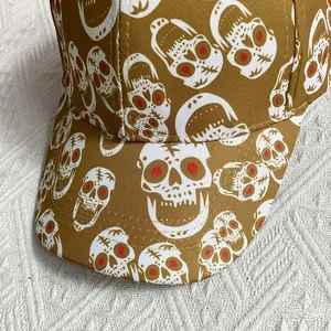 Detail shot of heavy canvas baseball cap featuring white skull print on brown fabric