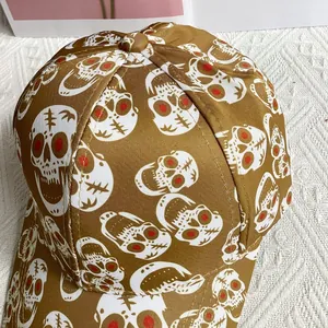Close-up of golden brown skull baseball cap with red eyes print and twill fabric texture