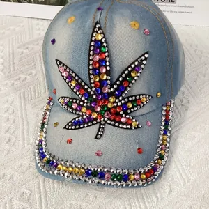 Detail of a denim baseball cap featuring a multi-color rhinestone maple leaf pattern