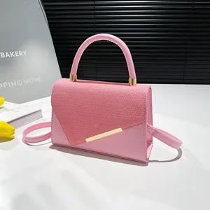 Pink fashion handbag for women with woven texture flap and golden hardware accents