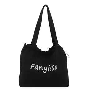 Large black canvas shoulder bag with white Fanyissa print and drawstring closure