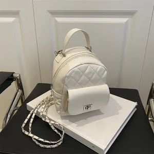 Mini white quilted backpack with silver hardware chain strap on a white background