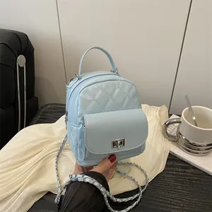 Mini light blue quilted backpack with silver clasp and chain strap for women