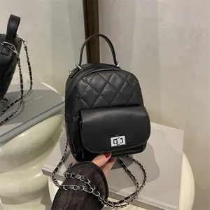 Mini quilted black leather backpack with silver chain straps and metallic twist lock