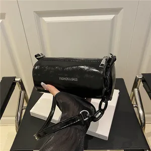 Chic black patent barrel bag with chunky chain strap and white fashion lettering