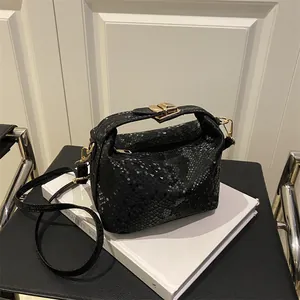 Borsa a bauletto nera a stampa serpente con hardware dorato e tracolla rimovibile