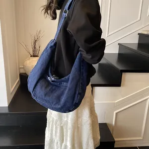 Japanese style large denim crossbody bag with vintage pocket detail and wide strap