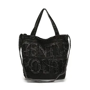 Large denim tote bag with Gentle Youth distressed embroidery and versatile shoulder straps