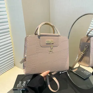 Elegant beige crossbody handbag with crocodile pattern and gold deer pendant