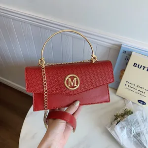 Red retro handbag with woven texture, golden M buckle, and chain strap for women