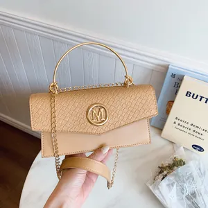 Beige faux crocodile leather crossbody bag with golden round handle and chain strap